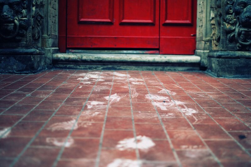 red door with footprints