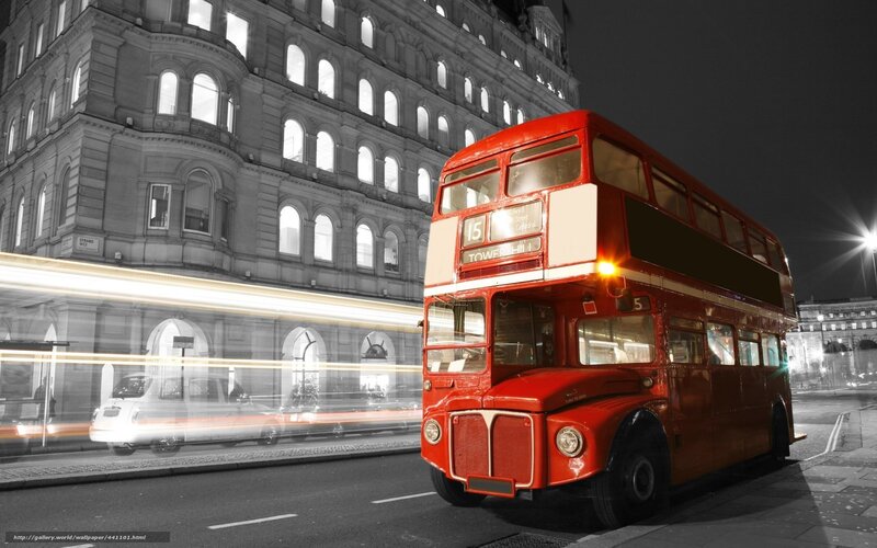Red double-decker bus at night