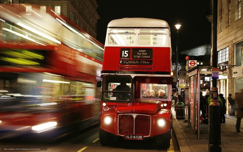Red double-decker buses at night