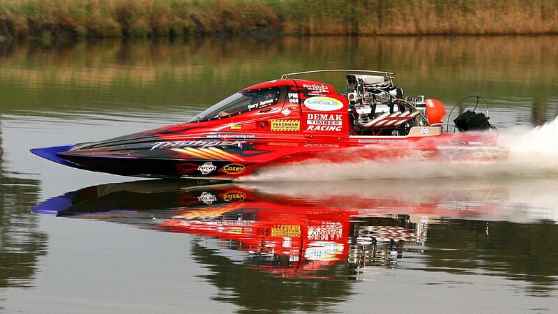 Red drag boat racing on water