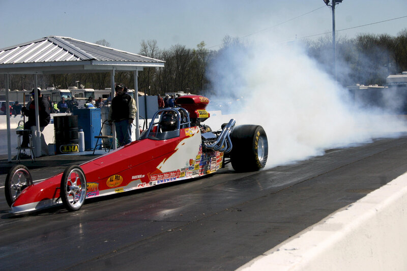 Red Drag Racing Car — Dynamic, Afternoon, Photograph, Smoke, Racetrack, Spectators