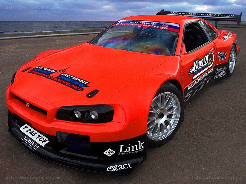 Red drift race car on beach
