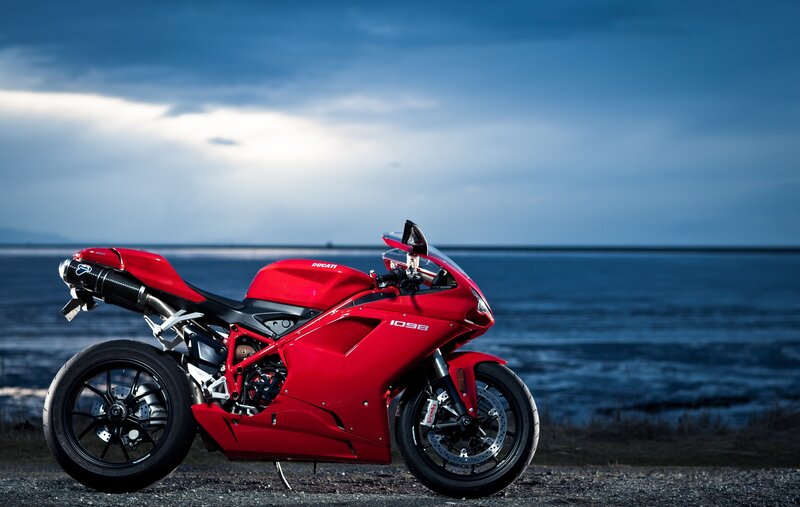 Red Ducati motorcycle by the sea