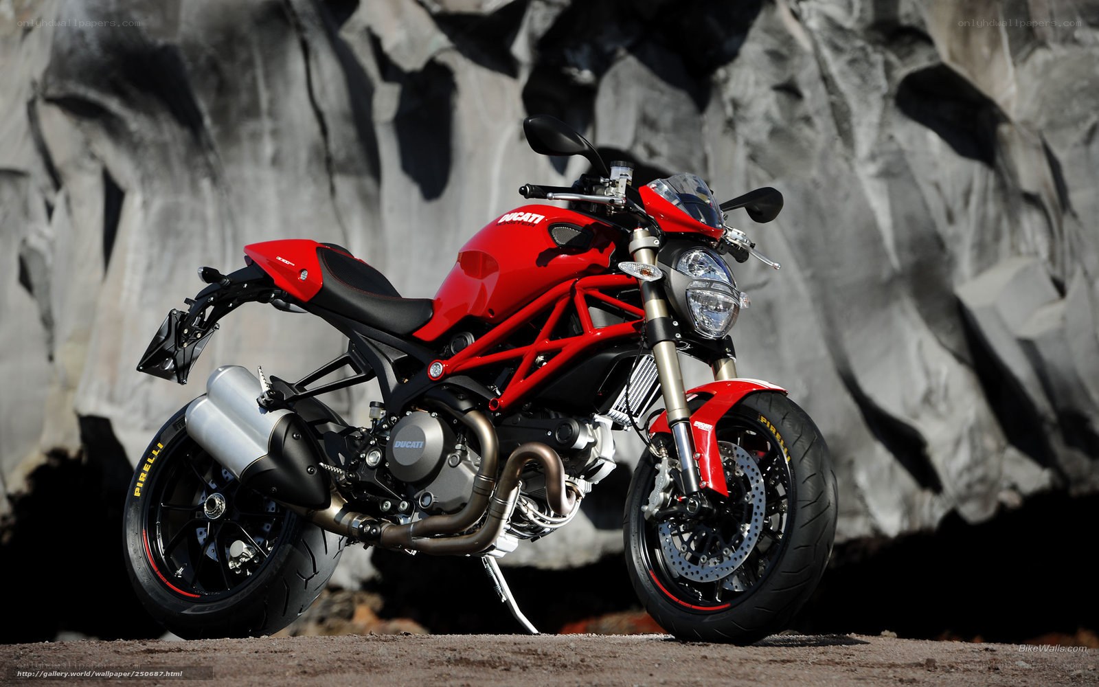 Red Ducati motorcycle on rocky terrain