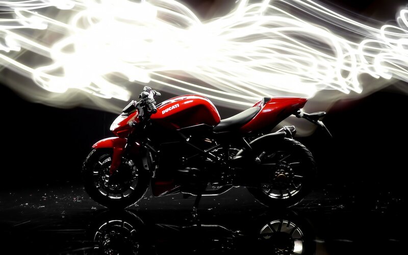 Red Ducati motorcycle with light trails