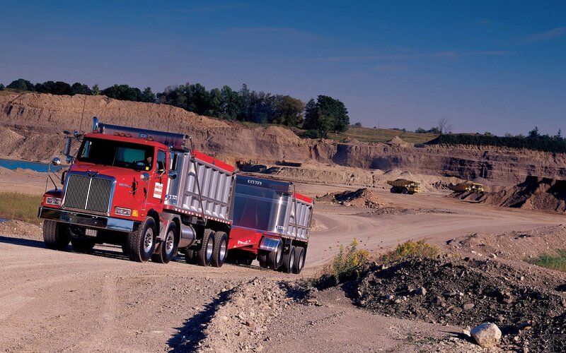 Red dump truck at quarry site