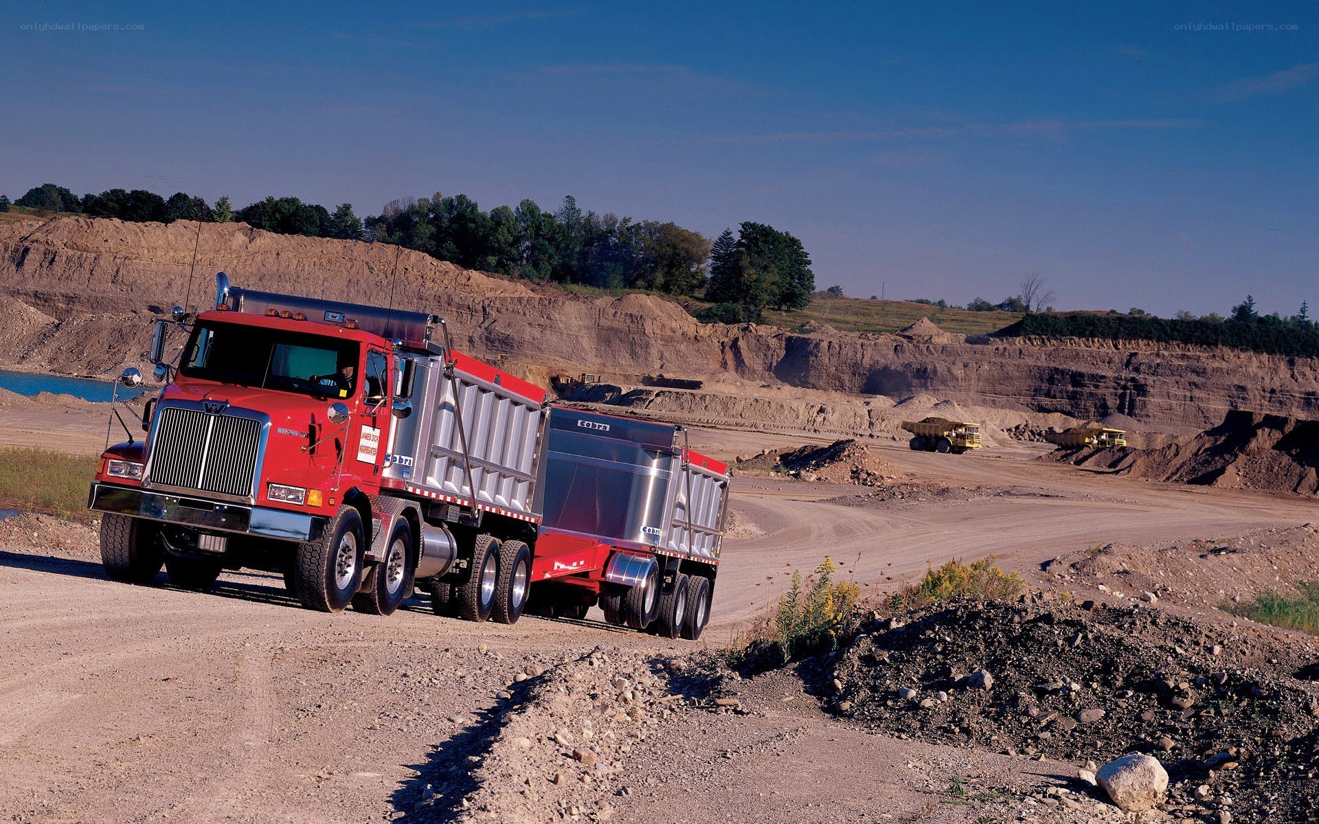 Red dump truck at quarry site