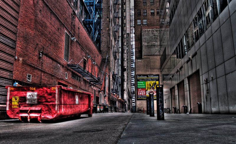 Red dumpster in alleyway