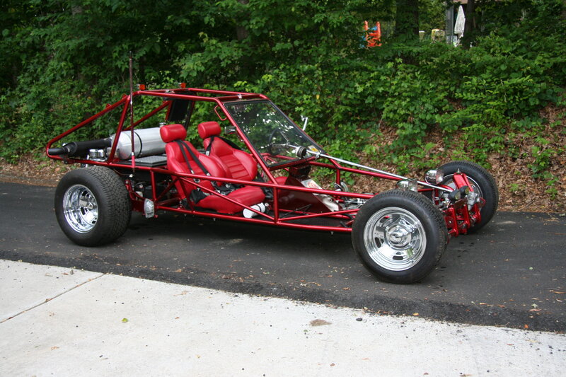Red dune buggy on asphalt