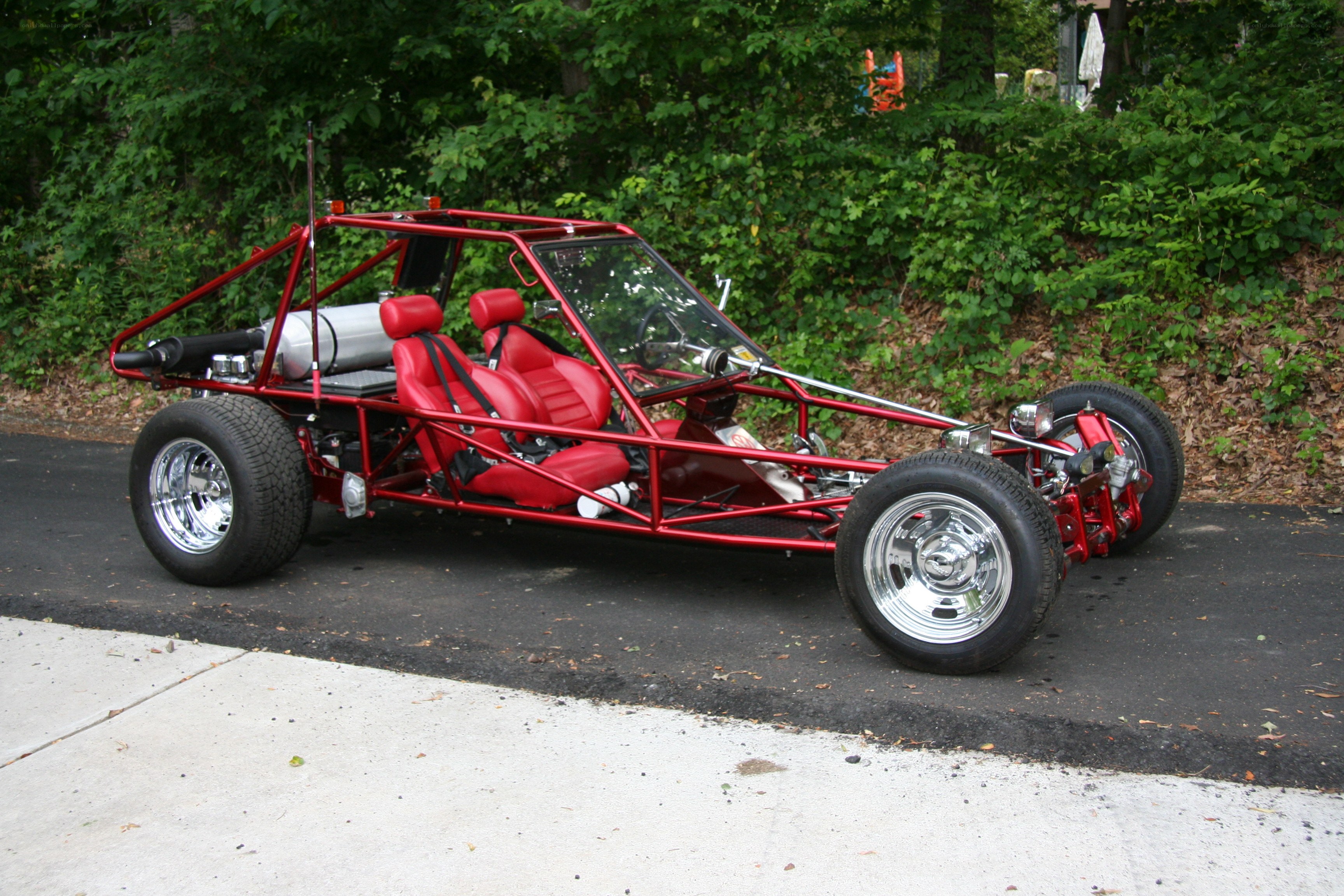 Red dune buggy on asphalt