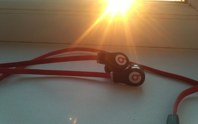 red earbuds in sunlight