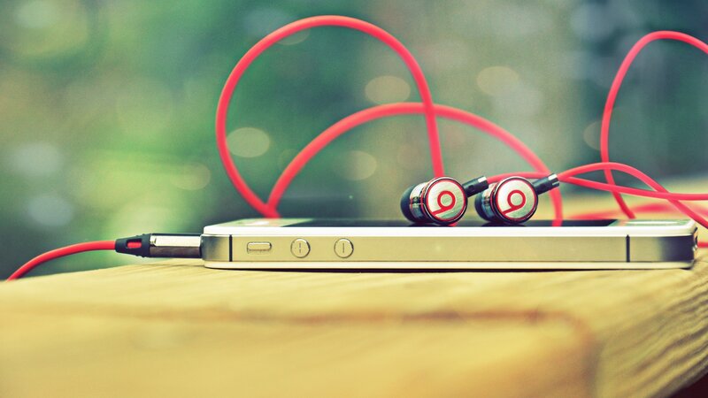 Red Earbuds on Phone — Calm, Photograph