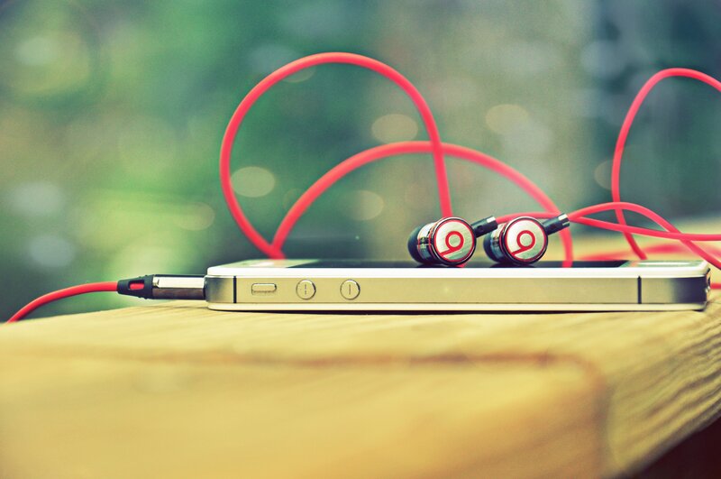 Red Earbuds on Phone — Calm