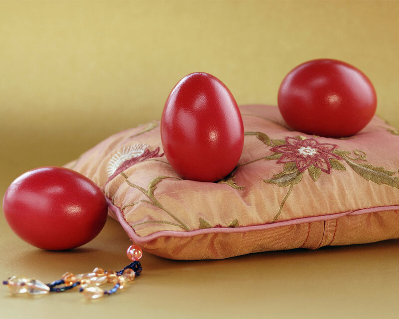 Red eggs on embroidered pillow