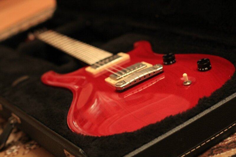 Red electric guitar in case