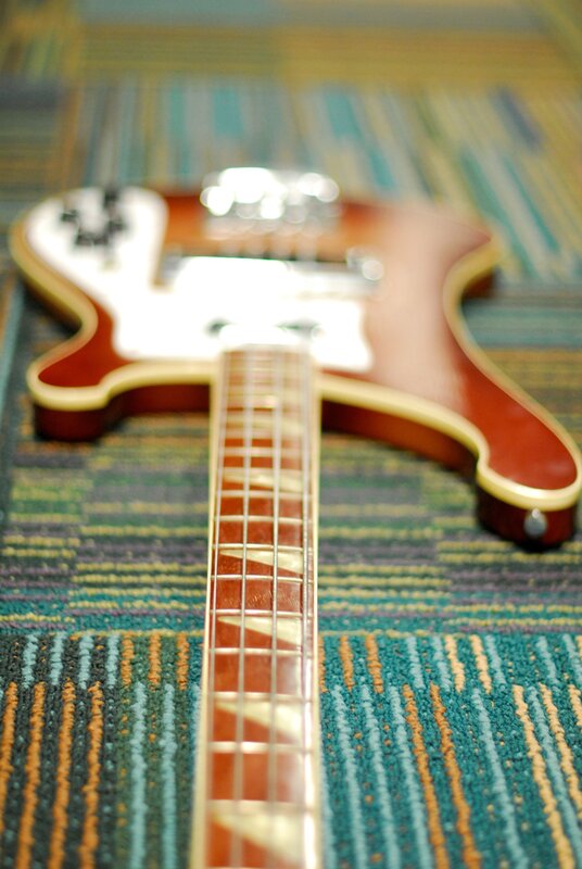 red electric guitar on carpet