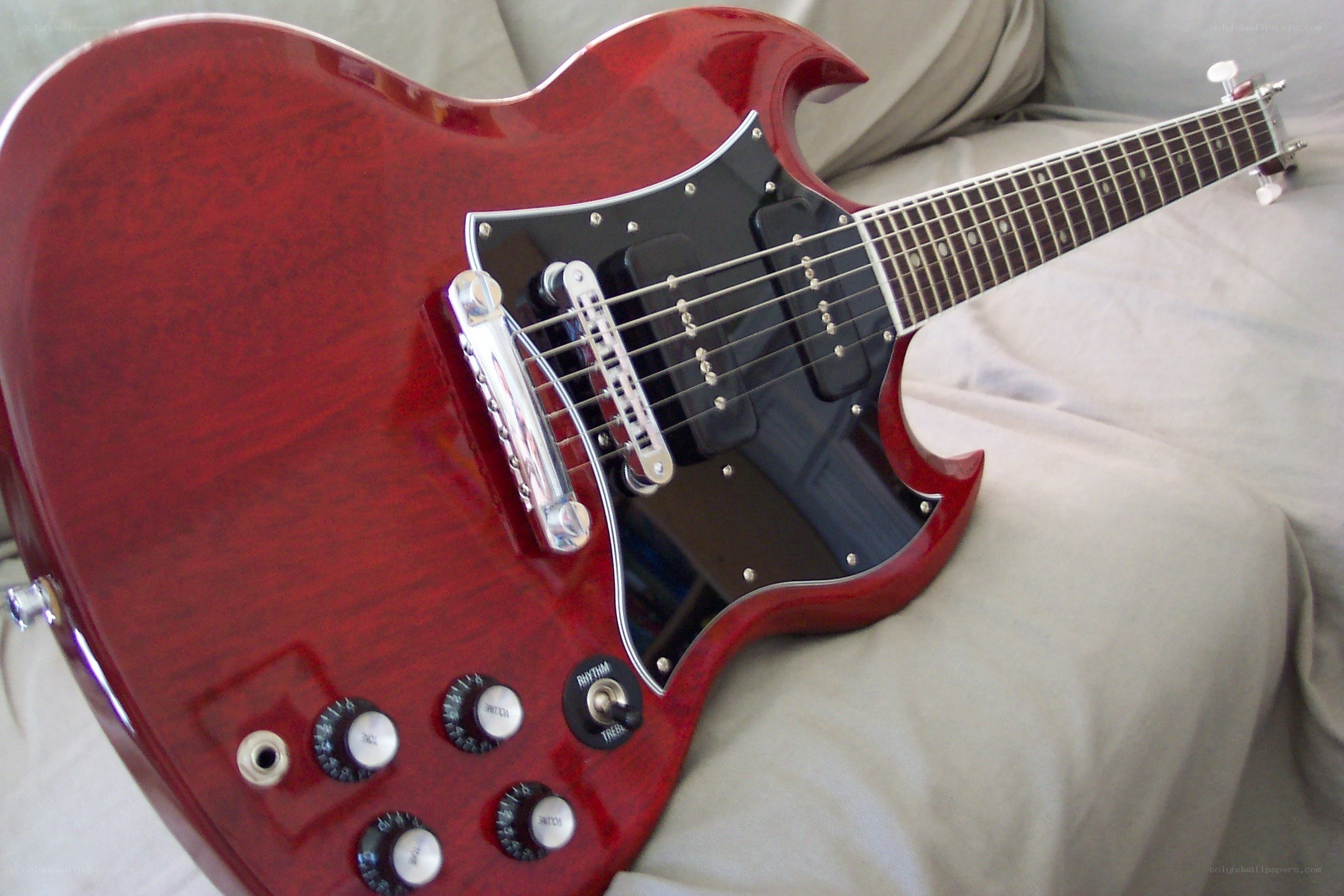 red electric guitar on couch