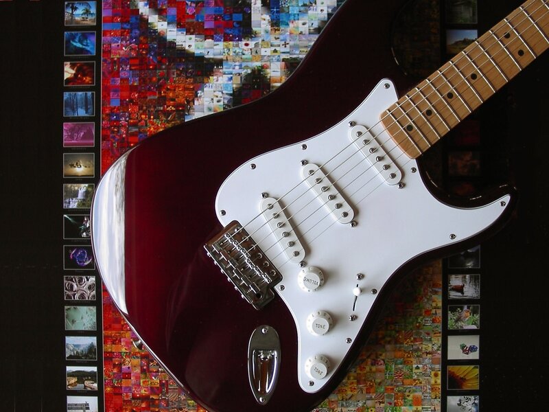 Red electric guitar on photo collage