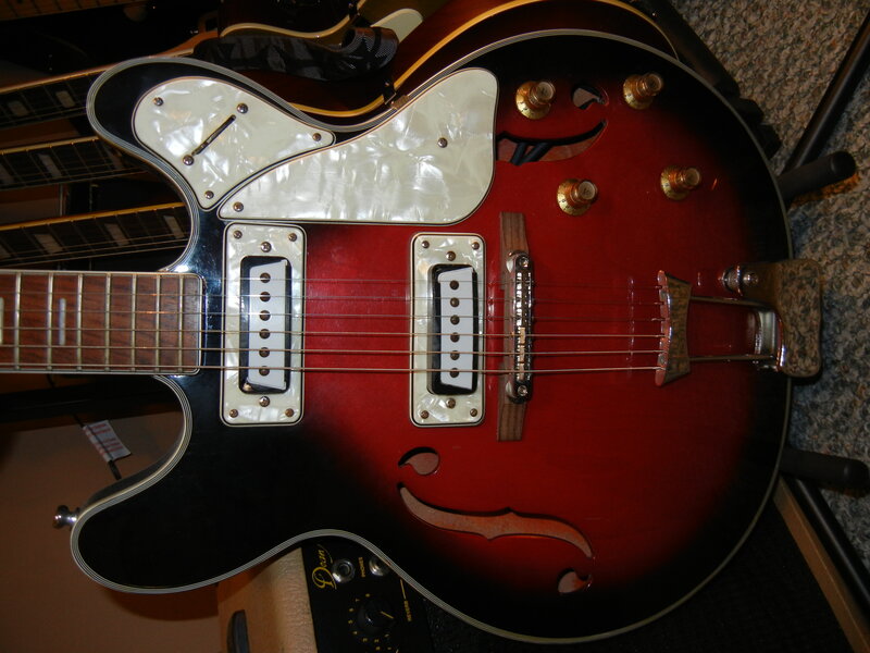 red electric guitar with white pickguard