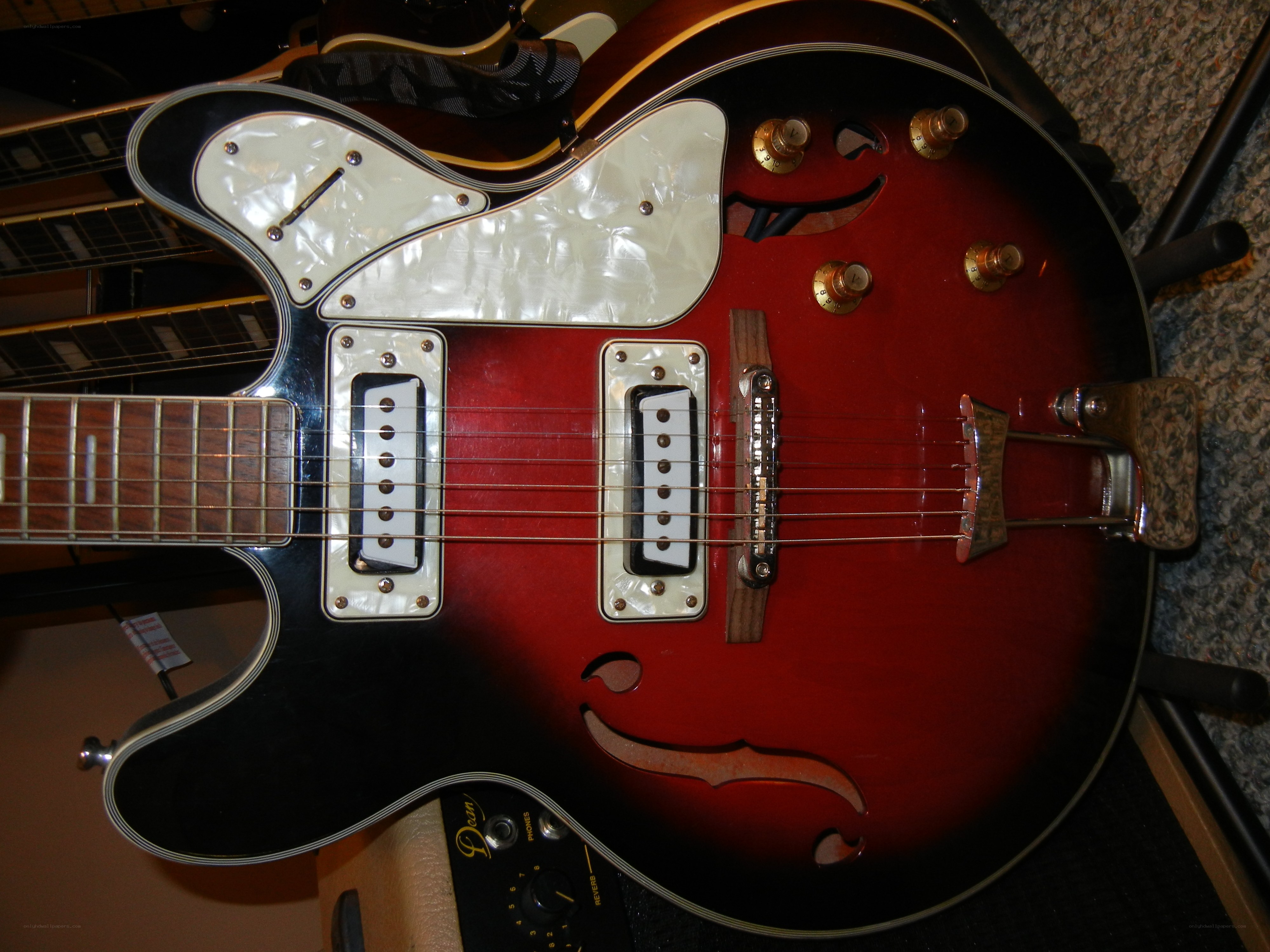 red electric guitar with white pickguard