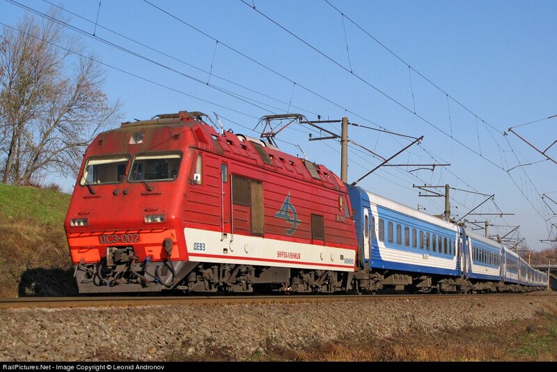 Red electric locomotive pulling train