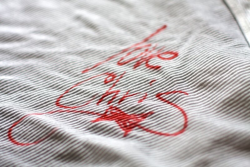 red embroidery on striped fabric