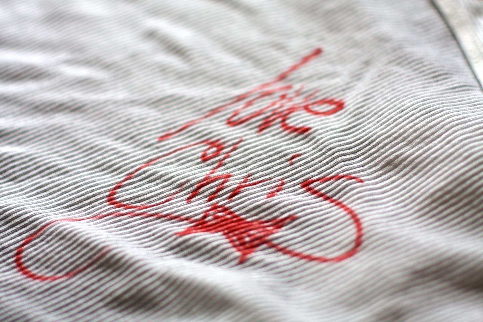 red embroidery on striped fabric