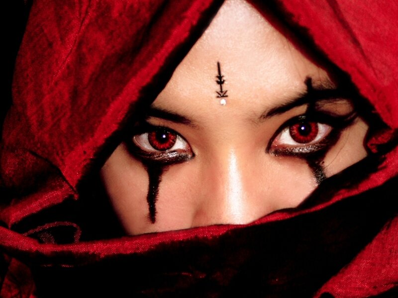 red-eyed figure in red hood