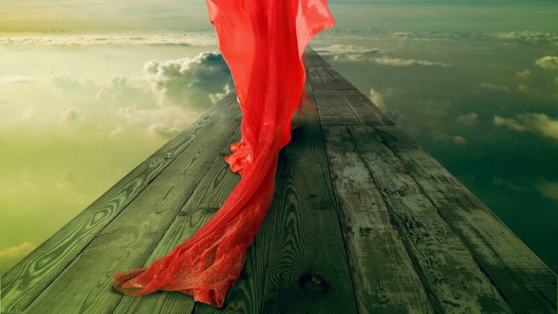 red fabric on wooden pier