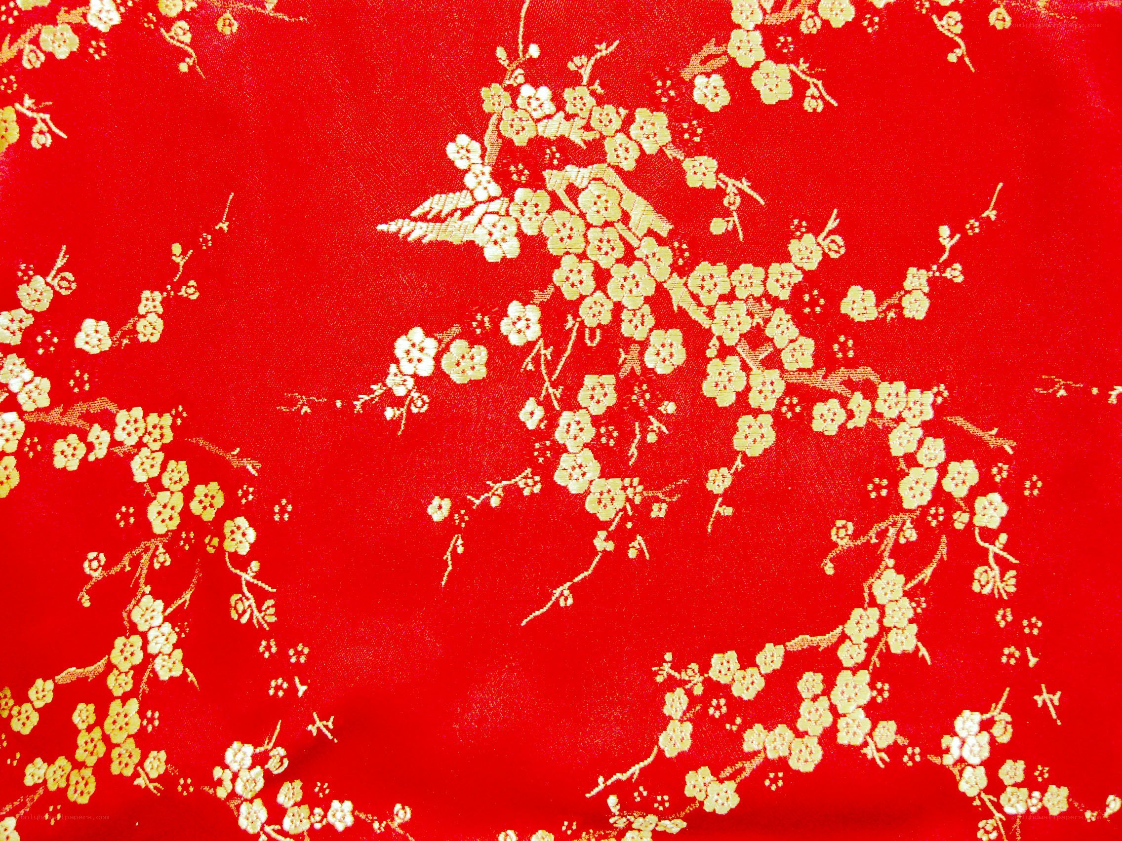 red fabric with gold floral pattern