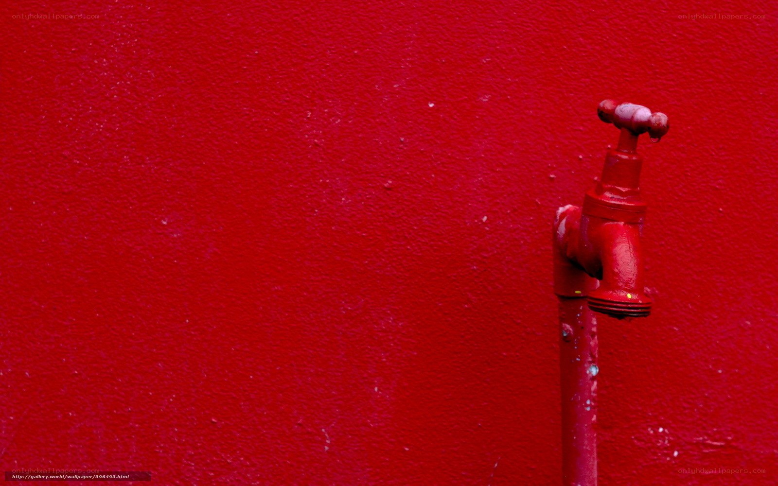 red faucet on red wall