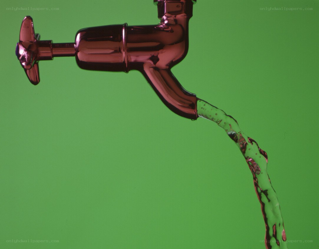Red faucet with flowing water