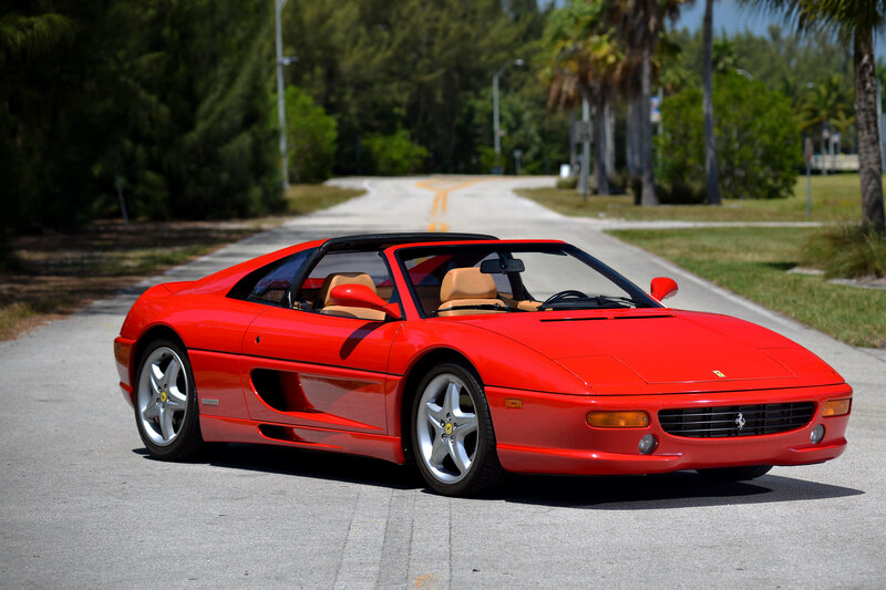 Red Ferrari 348 on a sunny road