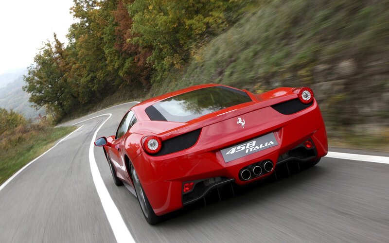 Red Ferrari 458 Italia on winding road