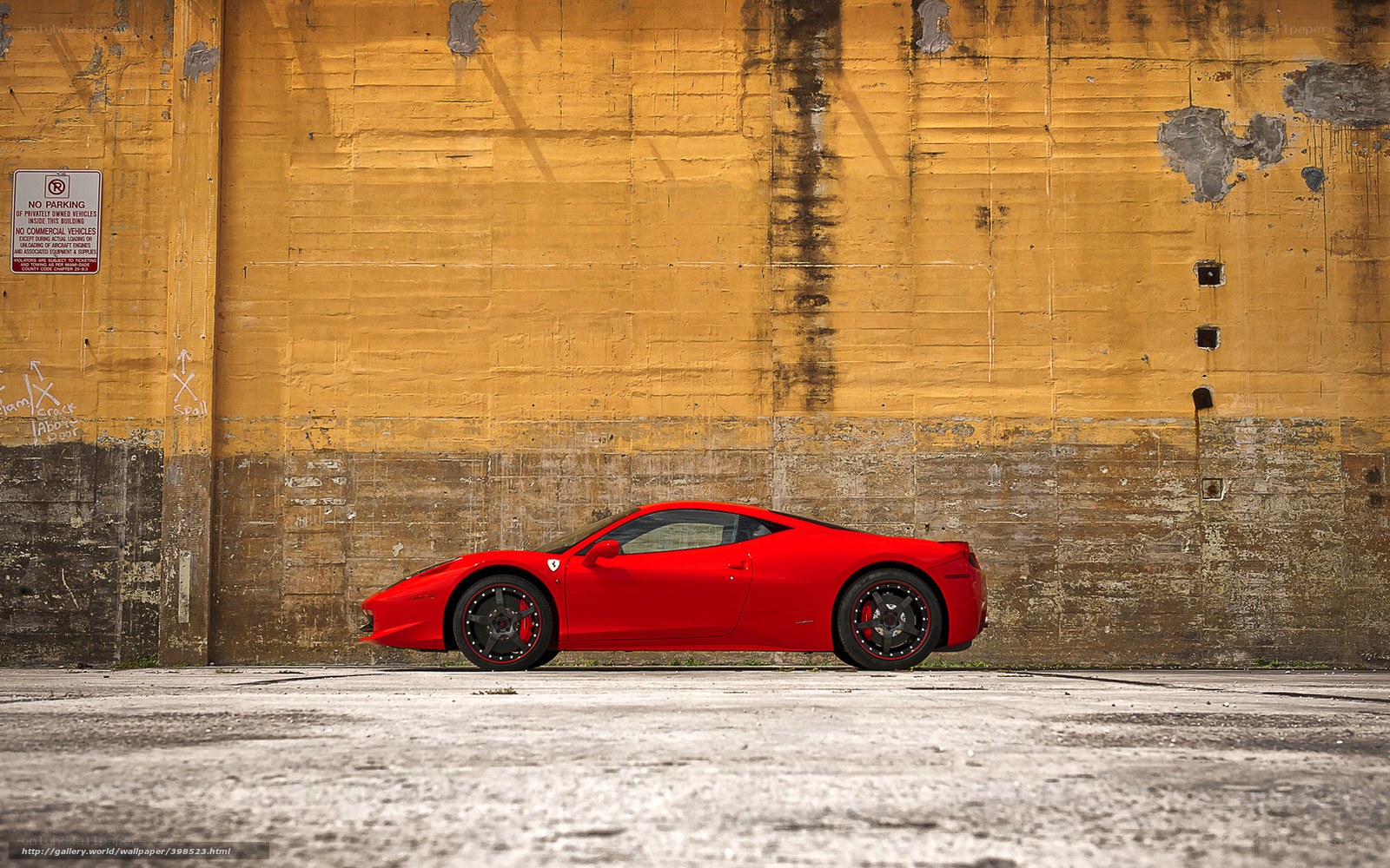 Red Ferrari against yellow wall