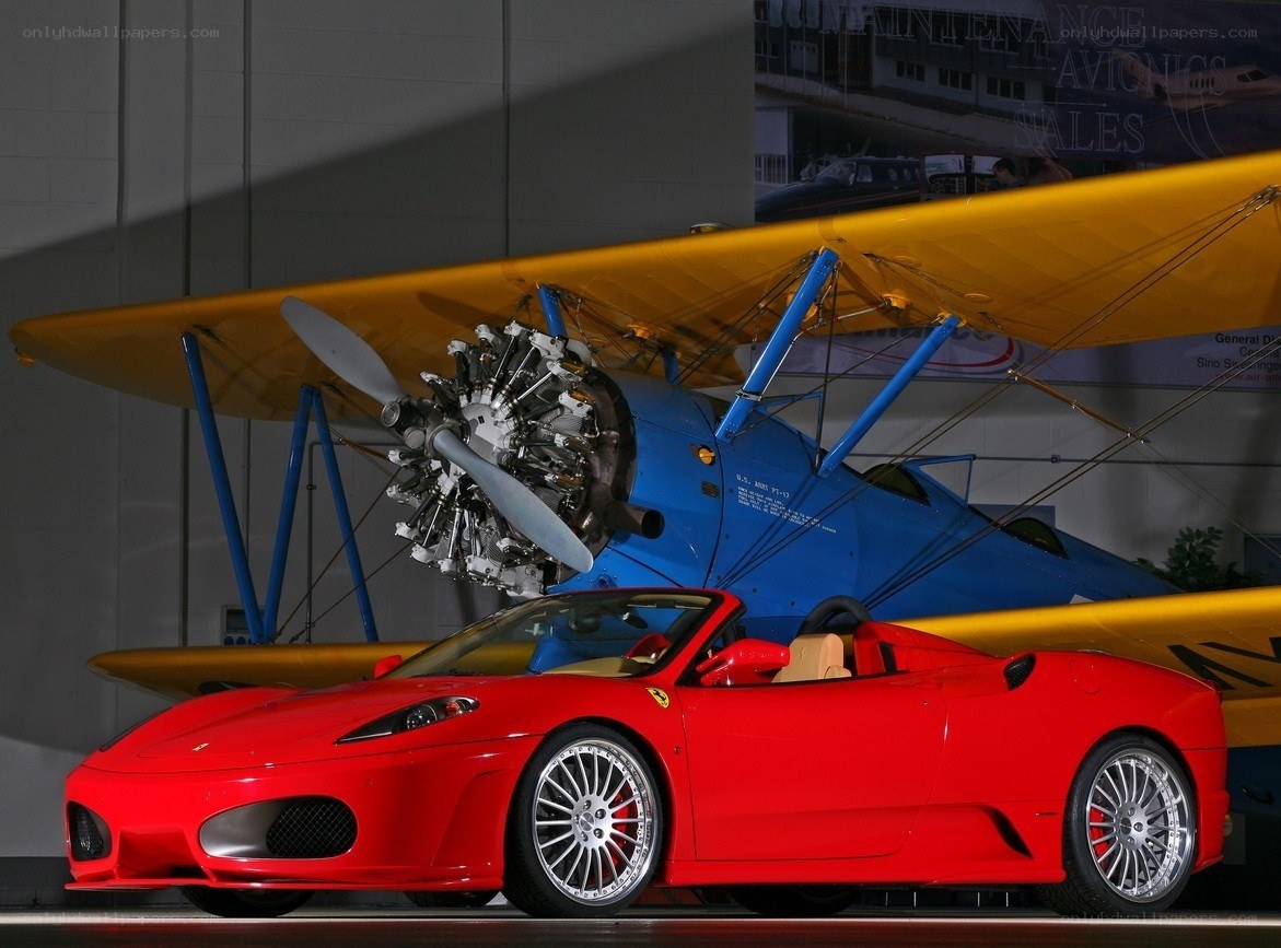 Red Ferrari and biplane display