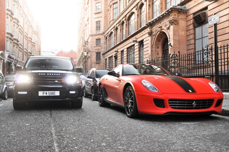 Red Ferrari and Black Range Rover
