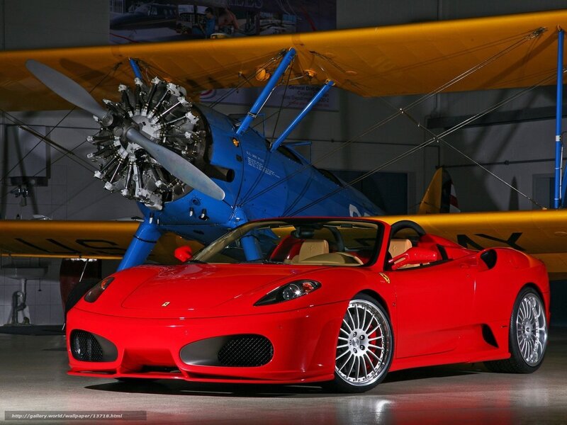 Red Ferrari and vintage airplane