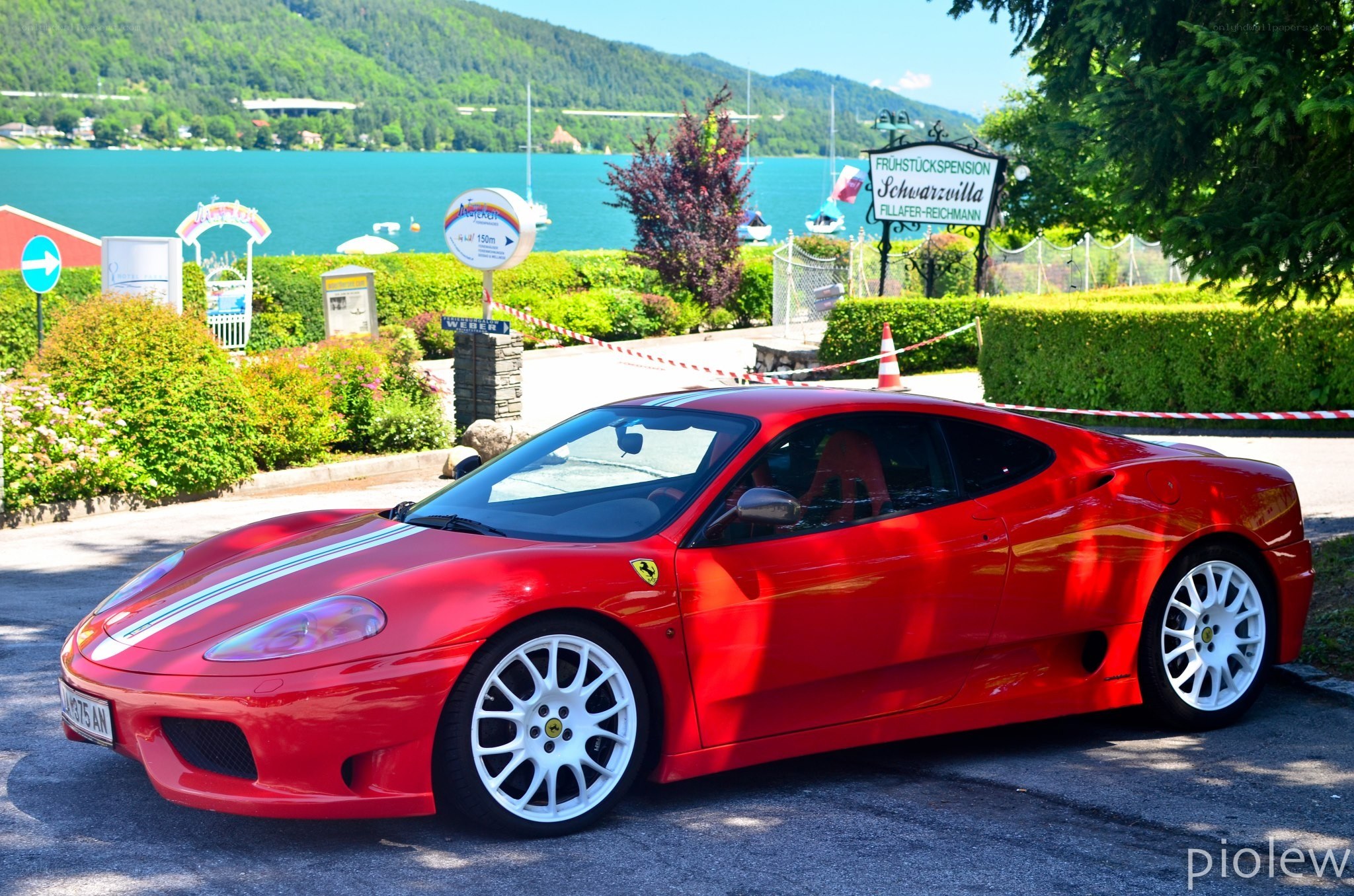 Red Ferrari at a lakeside resort