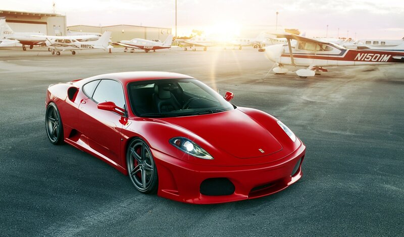 Red Ferrari at an airfield