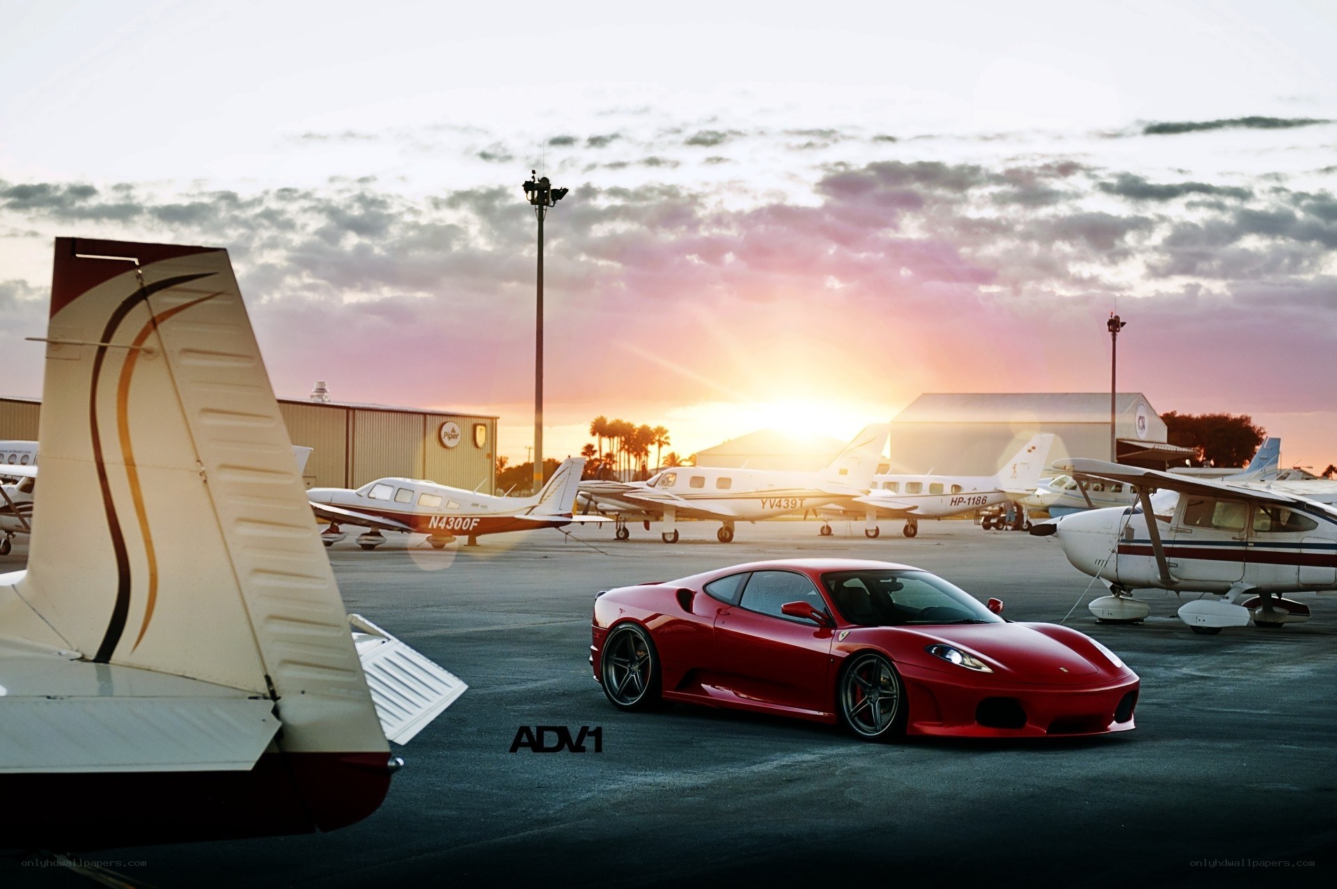 Red Ferrari at an airport