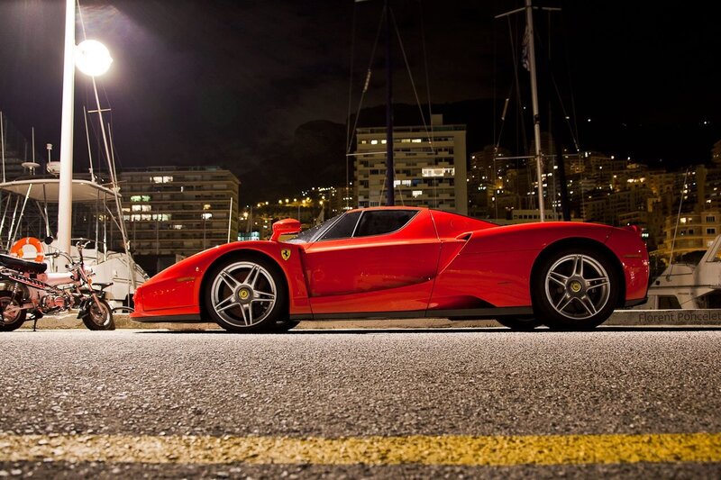 Red Ferrari at night by the harbor