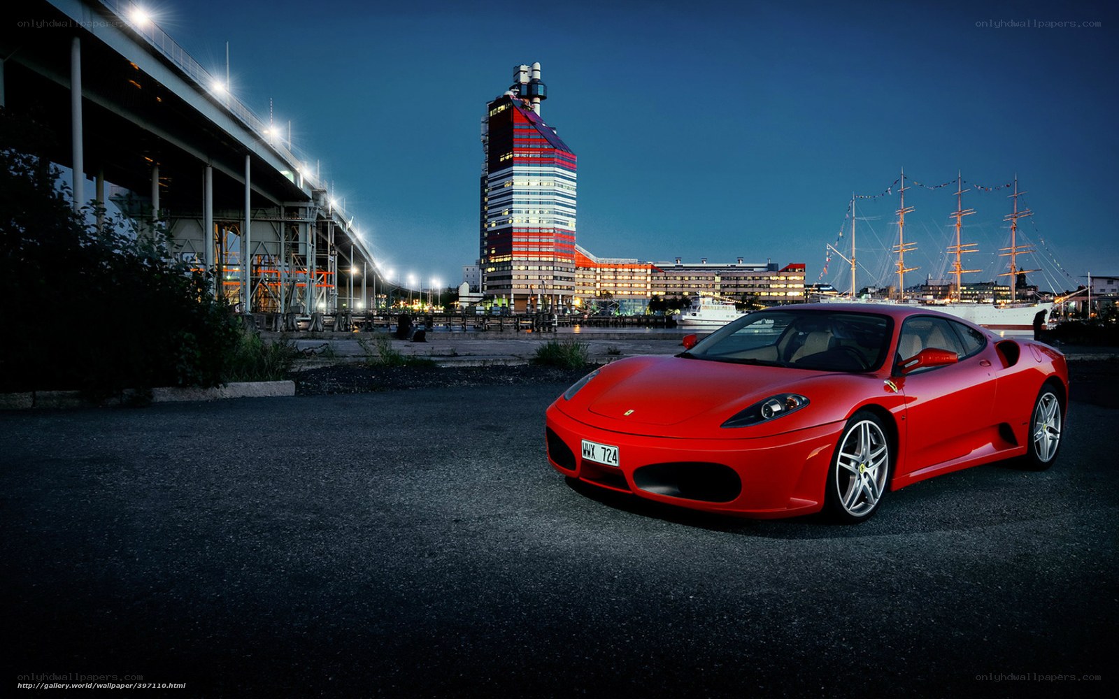 Red Ferrari at night by the harbor
