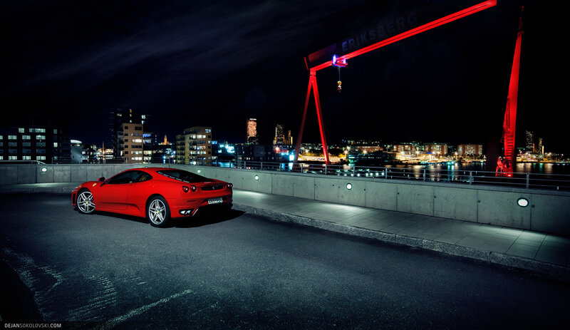 Red Ferrari at night by the water