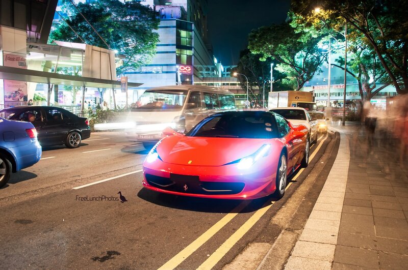 Red Ferrari at night in city