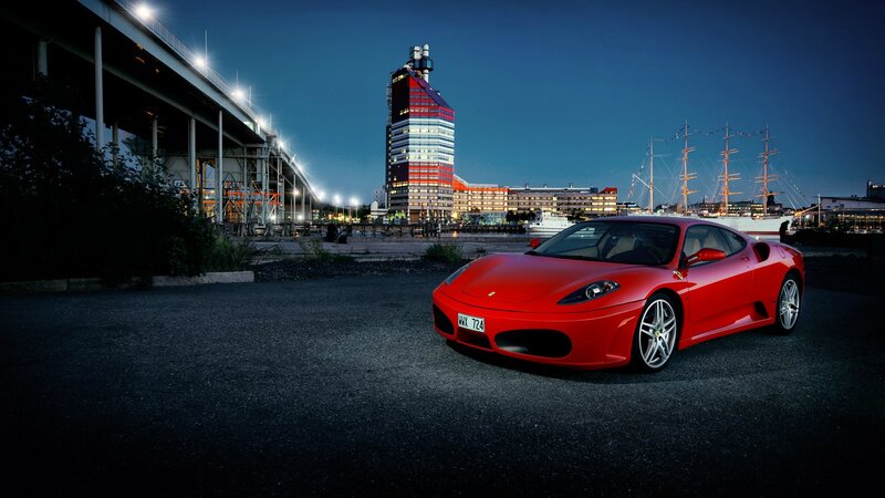 Red Ferrari at night in port