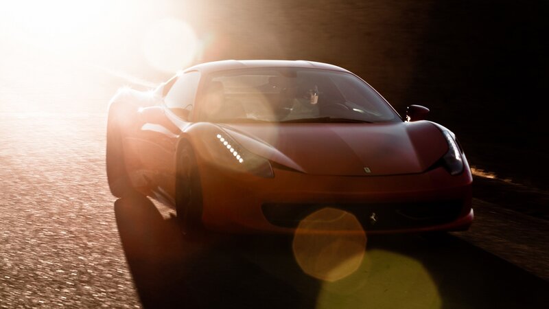 red ferrari at sunset