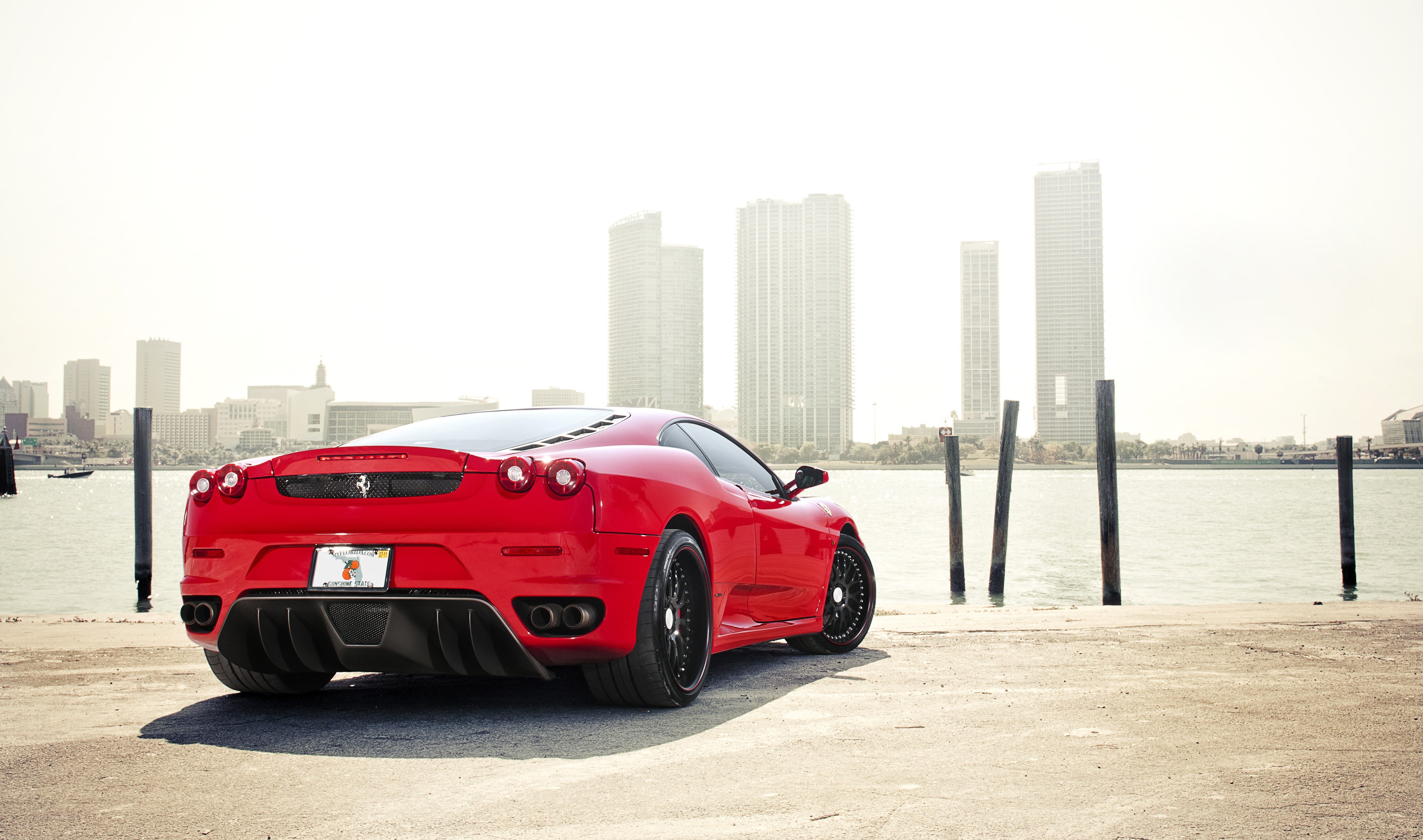 red ferrari at waterfront
