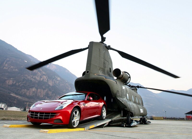 Red Ferrari being loaded into helicopter