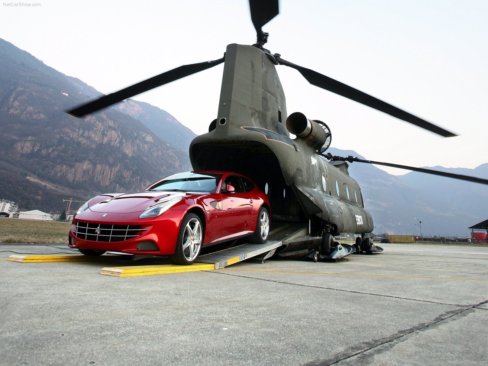 Red Ferrari being loaded into helicopter